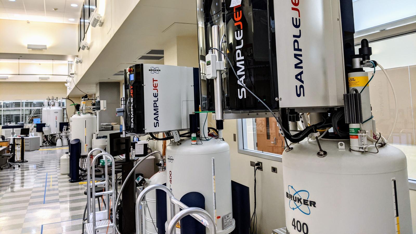 This image shows a laboratory setting with multiple Bruker NMR (Nuclear Magnetic Resonance) spectrometers.