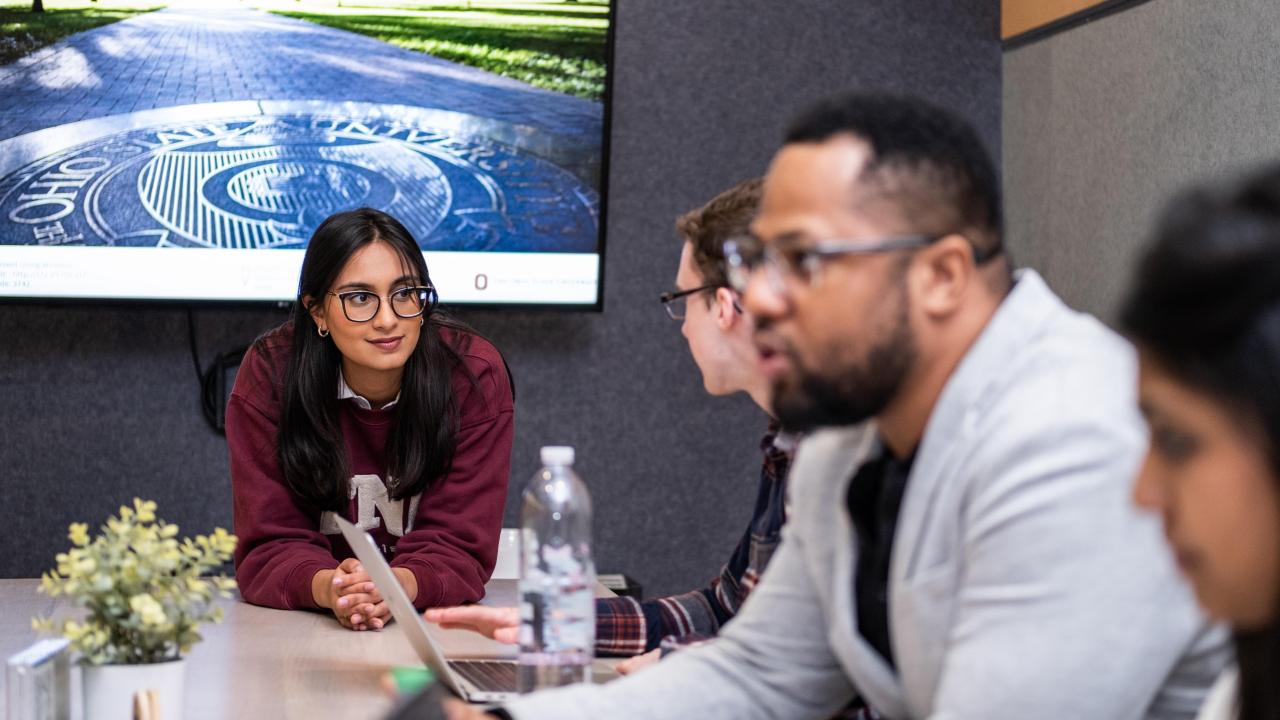 group of people having a discussion in a conference room